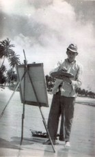 Hermano pintando na praia.